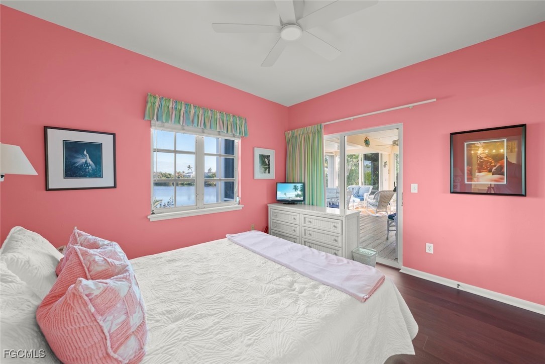 1401 Sand Castle Road Sanibel, FL 33957 - Photo 36 of 50 a bedroom with pink walls a bed and a large window