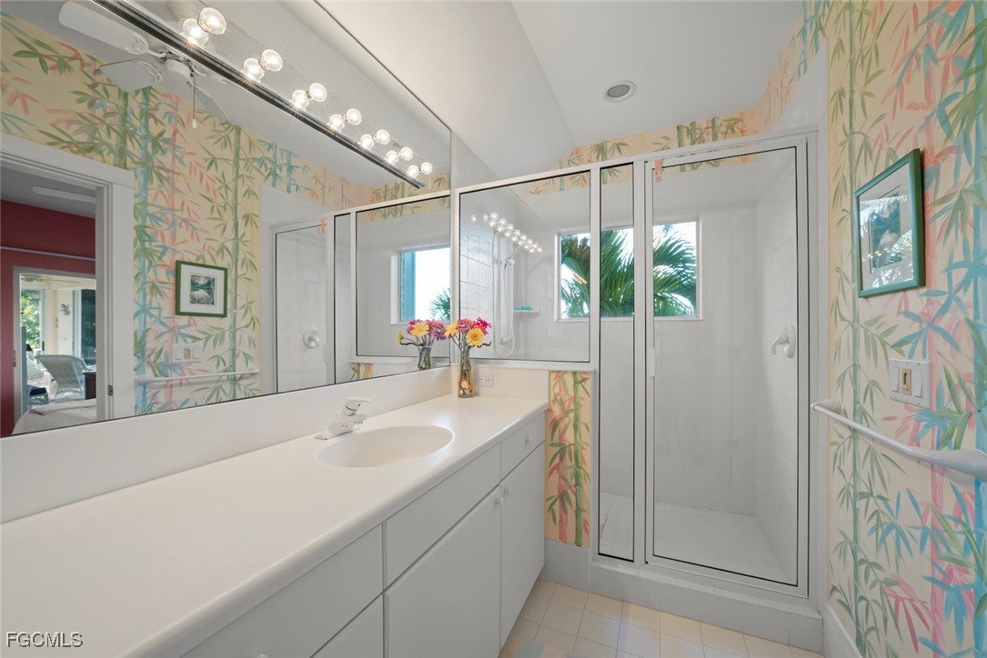 1401 Sand Castle Road Sanibel, FL 33957 - Photo 37 of 50 a bathroom with a double vanity sink and mirror