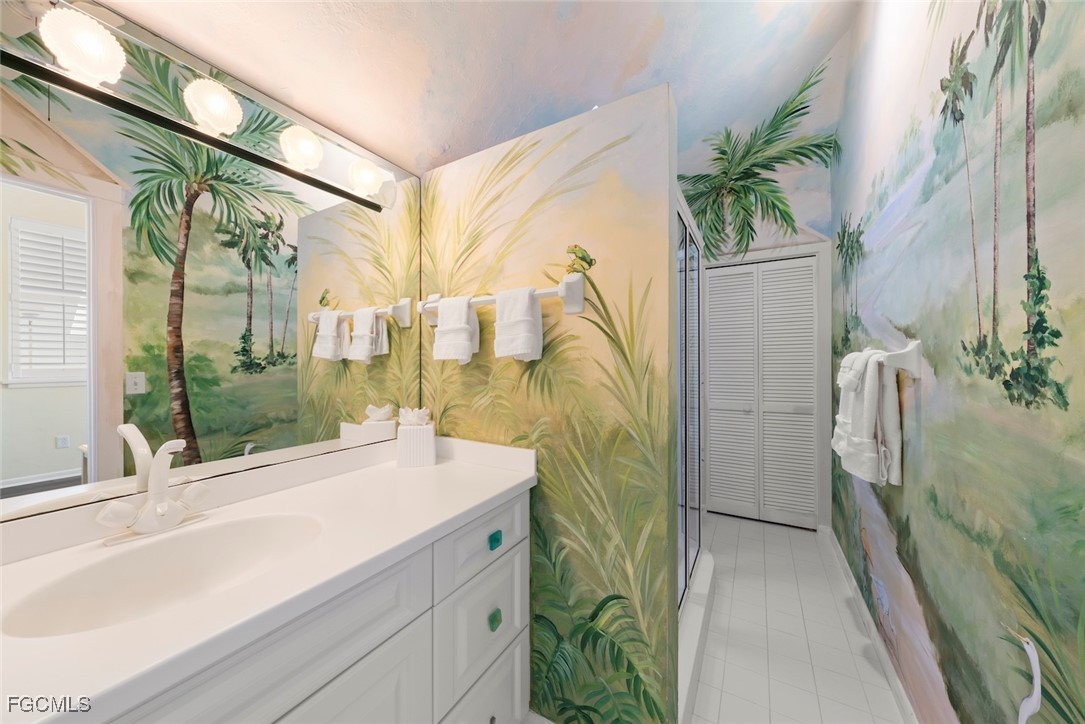 1401 Sand Castle Road Sanibel, FL 33957 - Photo 40 of 50 a bathroom with a sink a mirror and a shower