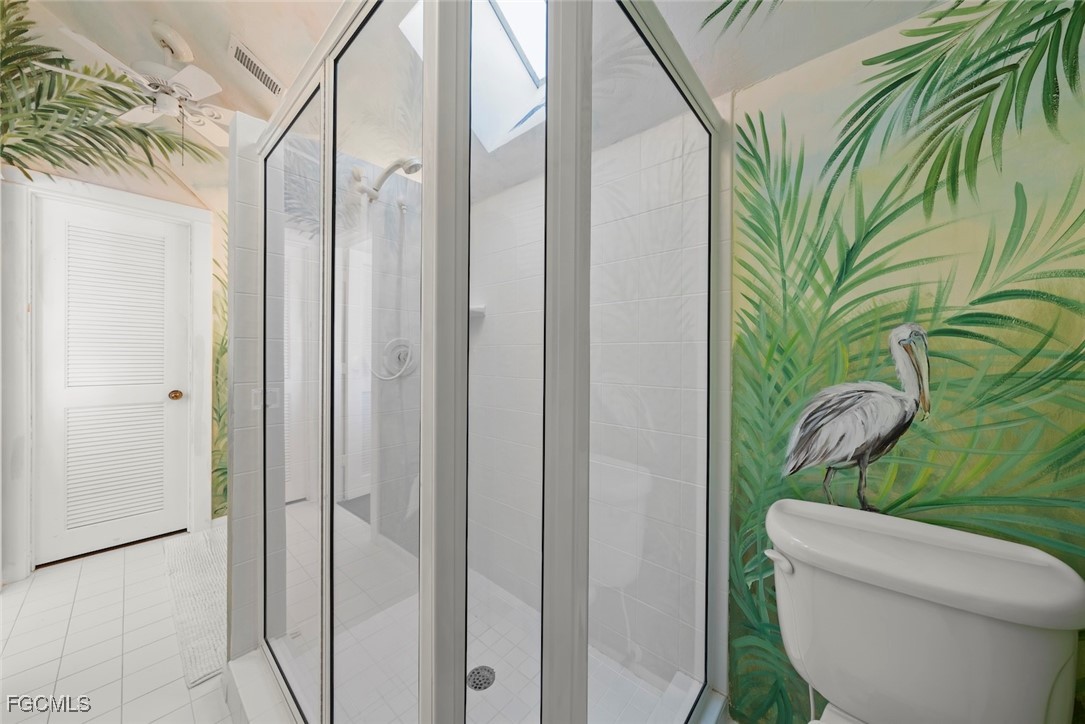 1401 Sand Castle Road Sanibel, FL 33957 - Photo 41 of 50 a bathroom with a toilet a sink and glass door