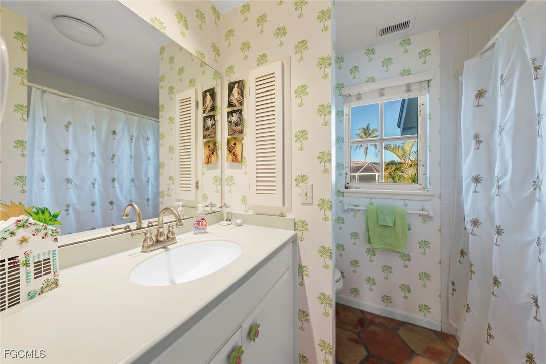 1401 Sand Castle Road Sanibel, FL 33957 - Photo 44 of 50 a bathroom with a sink a vanity and a mirror