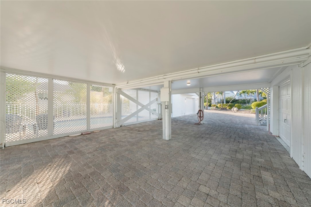 1401 Sand Castle Road Sanibel, FL 33957 - Photo 46 of 50 a view of an empty room with a sliding door and wooden floor