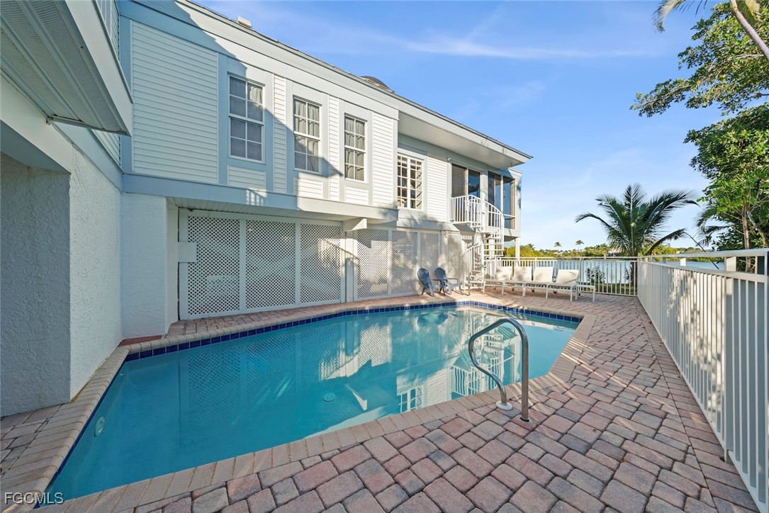 1401 Sand Castle Road Sanibel, FL 33957 - Photo 8 of 50 a house with swimming pool in front of it