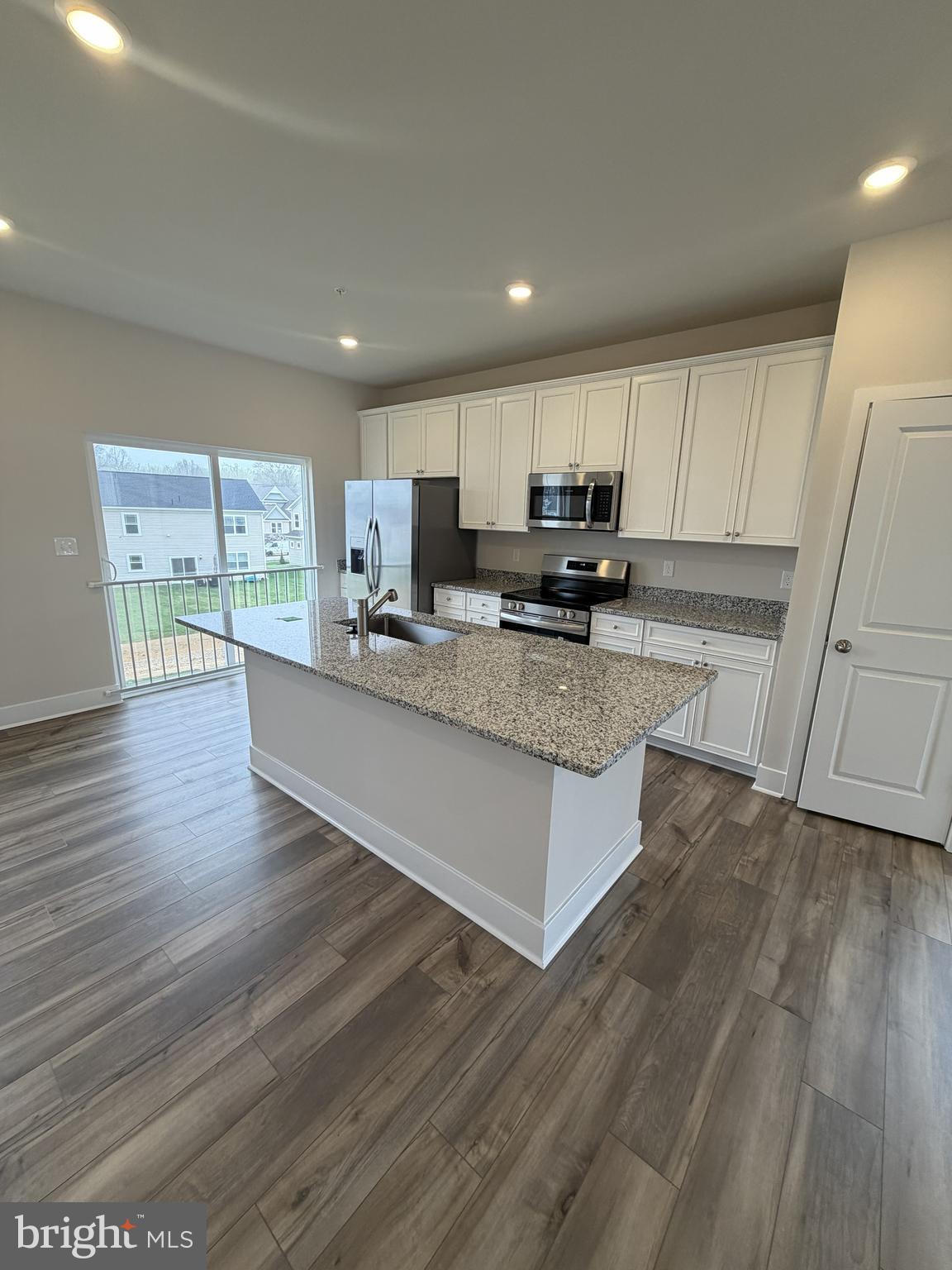 5511 Aberdeen Place White Plains, MD 20695 - Photo 4 of 6 a large kitchen with a center island wooden floor and stainless steel appliances