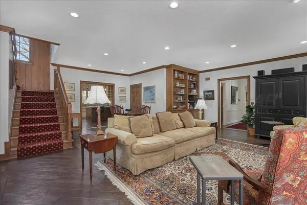 a bedroom with a bed and a refrigerator