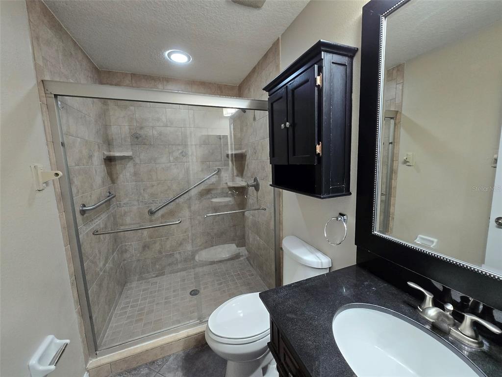 12905 Trade Port Place Riverview, FL 33579 - Photo 11 of 14 a bathroom with a sink a toilet and shower