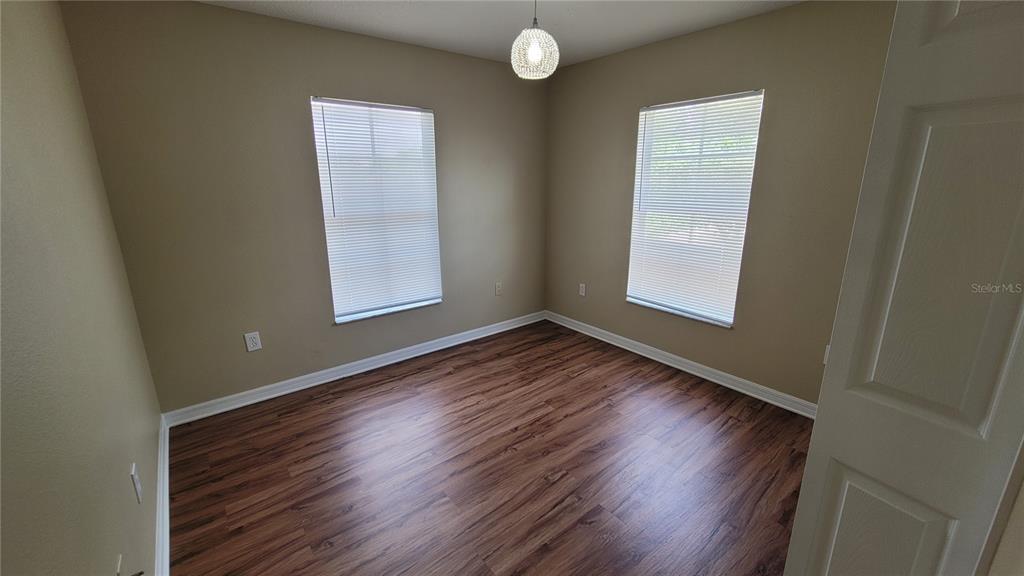 12905 Trade Port Place Riverview, FL 33579 - Photo 13 of 14 an empty room with wooden floor and windows