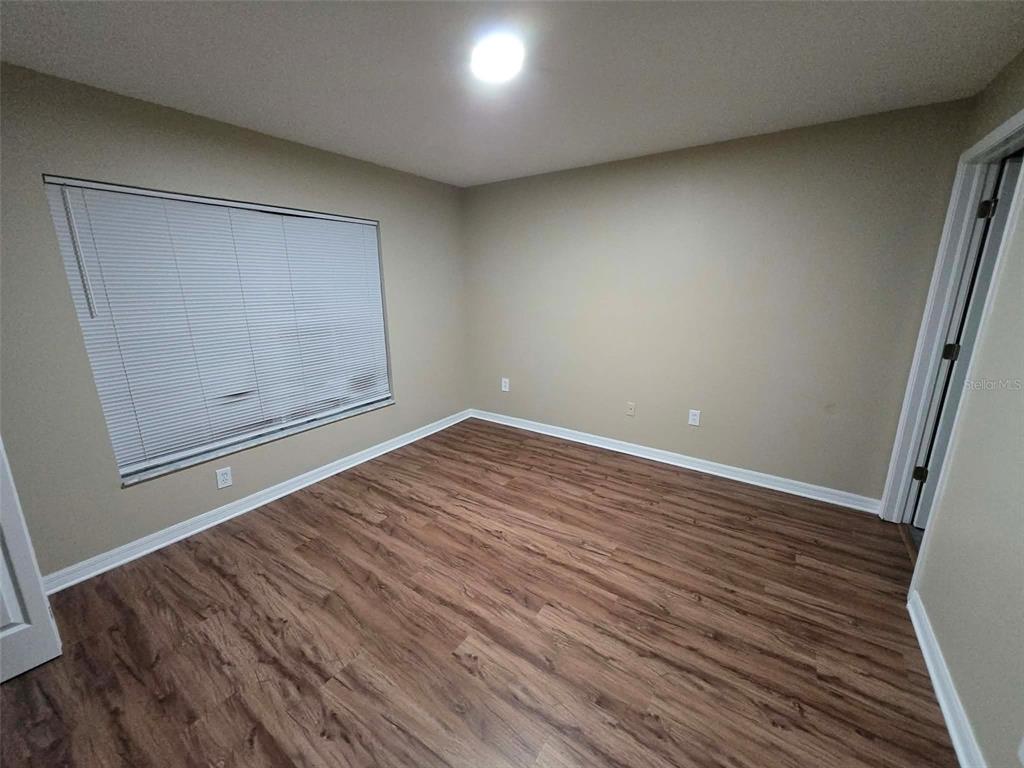 12905 Trade Port Place Riverview, FL 33579 - Photo 14 of 14 an empty room with wooden floor and windows