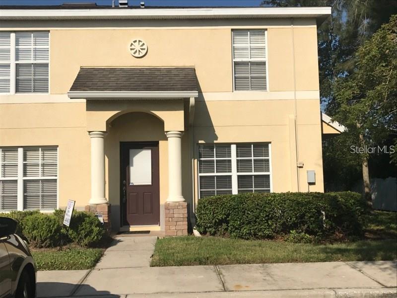 12905 Trade Port Place Riverview, FL 33579 - Photo 2 of 14 a front view of a house with garden