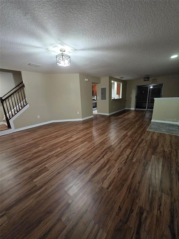 12905 Trade Port Place Riverview, FL 33579 - Photo 4 of 14 an empty room with wooden floor and windows
