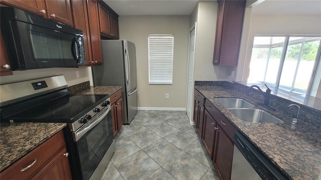 12905 Trade Port Place Riverview, FL 33579 - Photo 6 of 14 a kitchen that has a sink and a stove