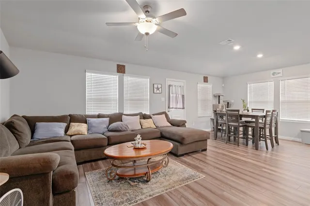 a living room with furniture a rug and a chandelier