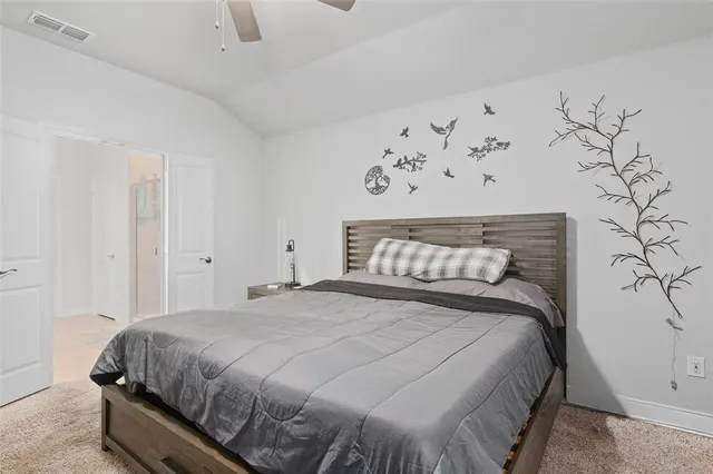 a bedroom with a bed and wall painting