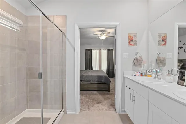 a en suite bathroom with a sink a mirror and a shower
