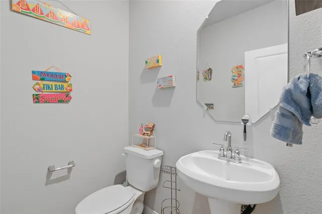 a bathroom with a toilet a sink and a mirror