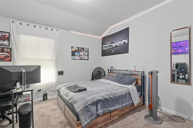 a bedroom with a bed and a desk