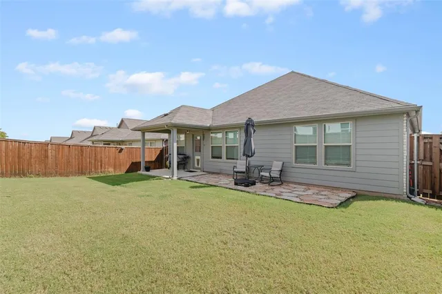 a view of a house with backyard porch and sitting area
