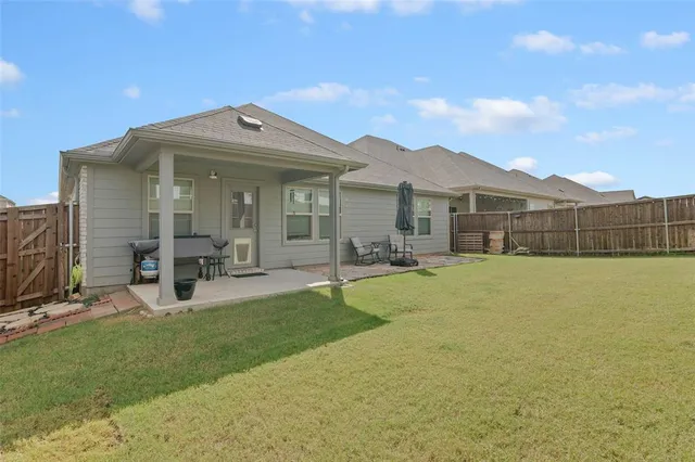 a view of a house with patio and garden