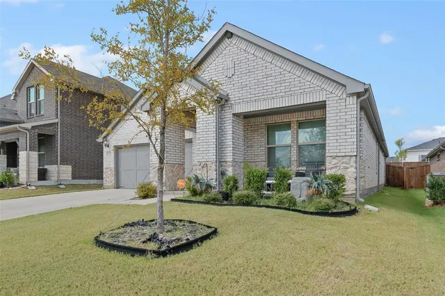 a front view of a house with a garden and patio