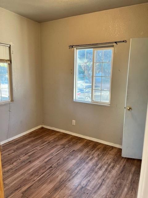 325 North 7th Street Fowler, CA 93625 - Photo 5 of 10 an empty room with wooden floor and windows