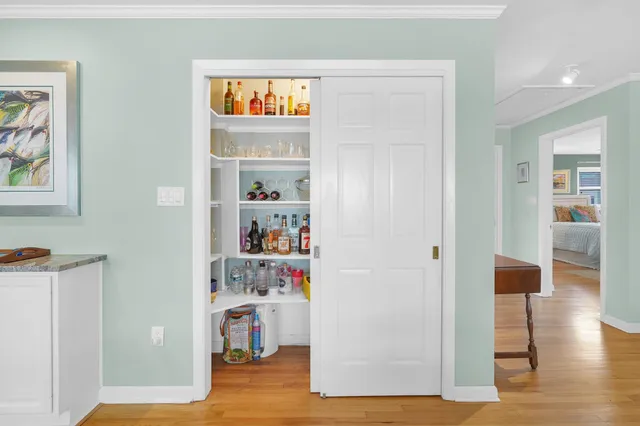 a view of living room with furniture and wooden floor