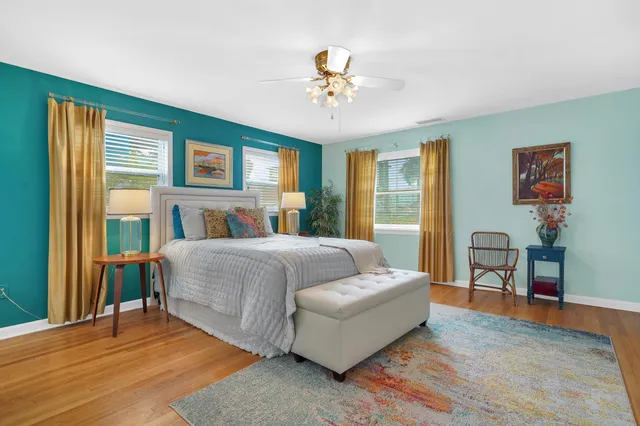 a bedroom with a bed and wooden floor
