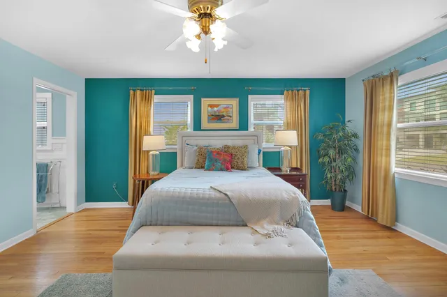 a bedroom with a large bed and a chandelier