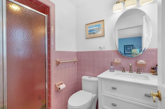 a bathroom with a toilet a sink and mirror