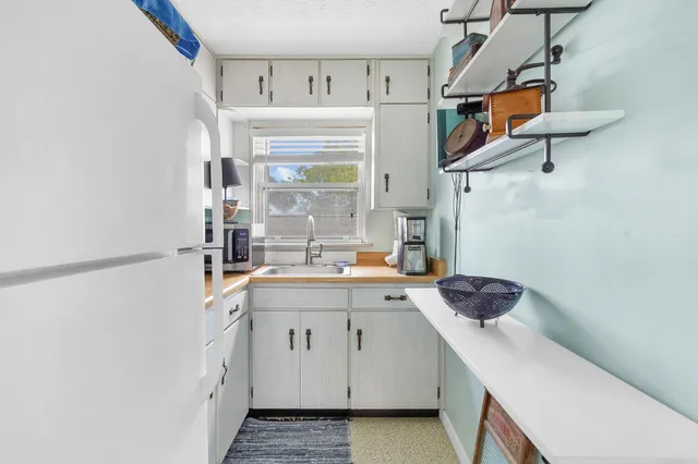 a kitchen with a sink cabinets and window