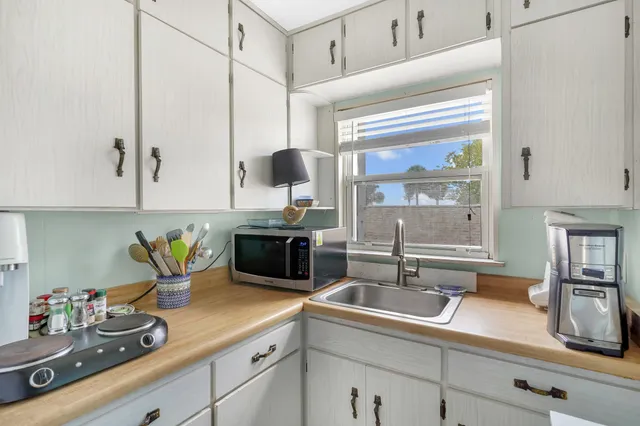 a kitchen with sink a counter and cabinets
