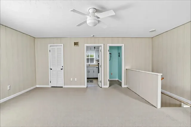 a view of empty room with ceiling fan