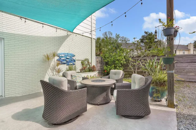 a outdoor dining space with furniture and potted plants