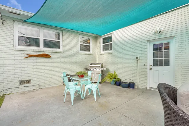 a backyard of a house with table and chairs