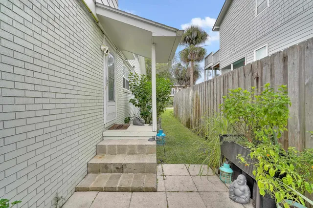 a view of patio with chairs and potted plants