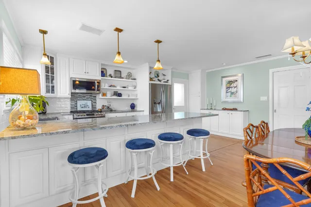 a kitchen with a dining table and chairs