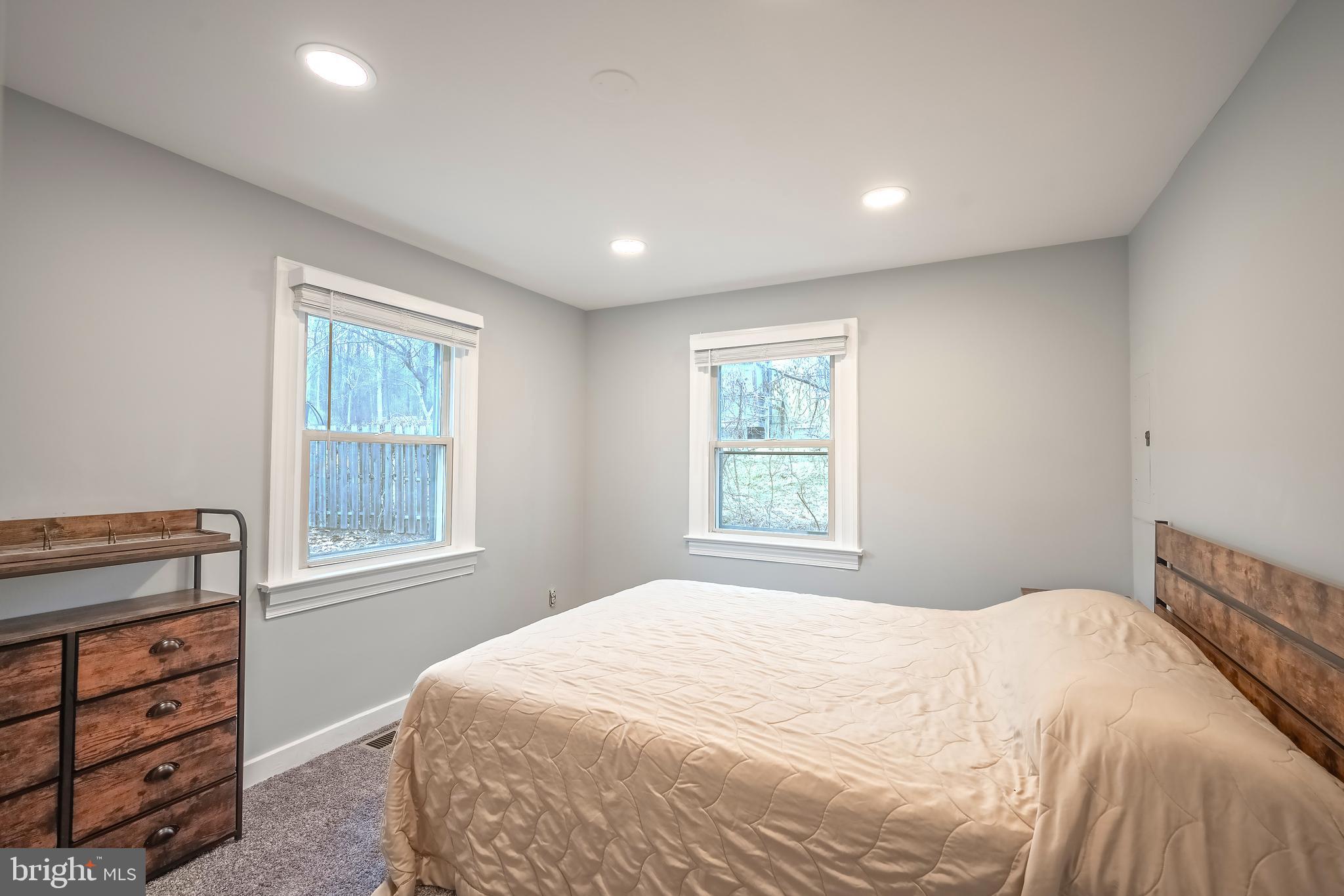 6946 Blantyre Road Warrenton, VA 20187 - Photo 12 of 24 a bedroom with a bed and a window