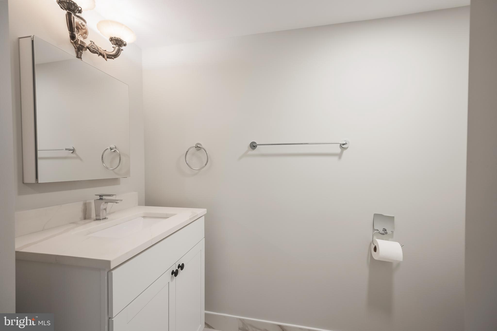 6946 Blantyre Road Warrenton, VA 20187 - Photo 15 of 24 a bathroom with a sink and a mirror