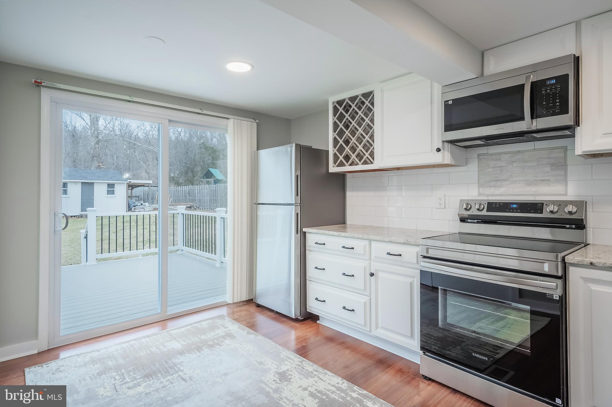 6946 Blantyre Road Warrenton, VA 20187 - Photo 18 of 24 a kitchen with a stove and a microwave