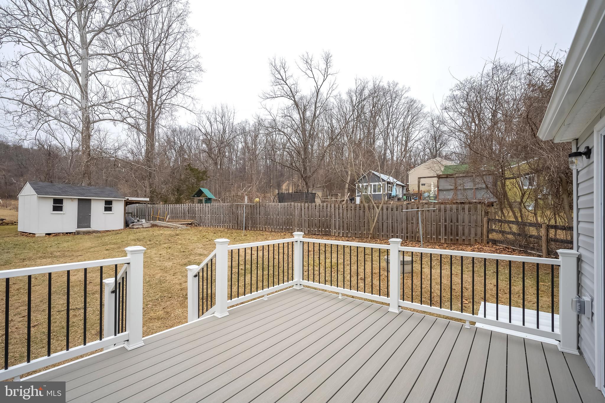 6946 Blantyre Road Warrenton, VA 20187 - Photo 19 of 24 a view of a balcony with wooden floor and fence
