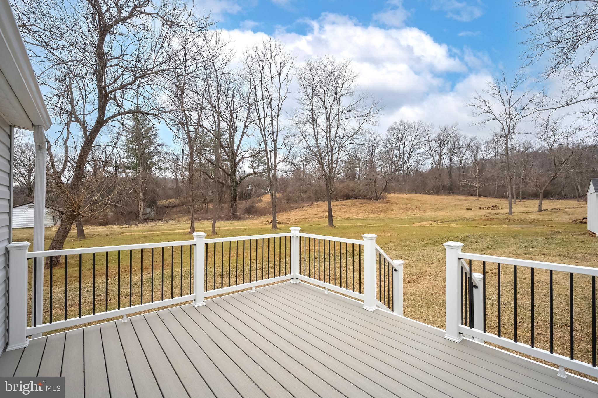 6946 Blantyre Road Warrenton, VA 20187 - Photo 20 of 24 a view of a wooden deck with a yard