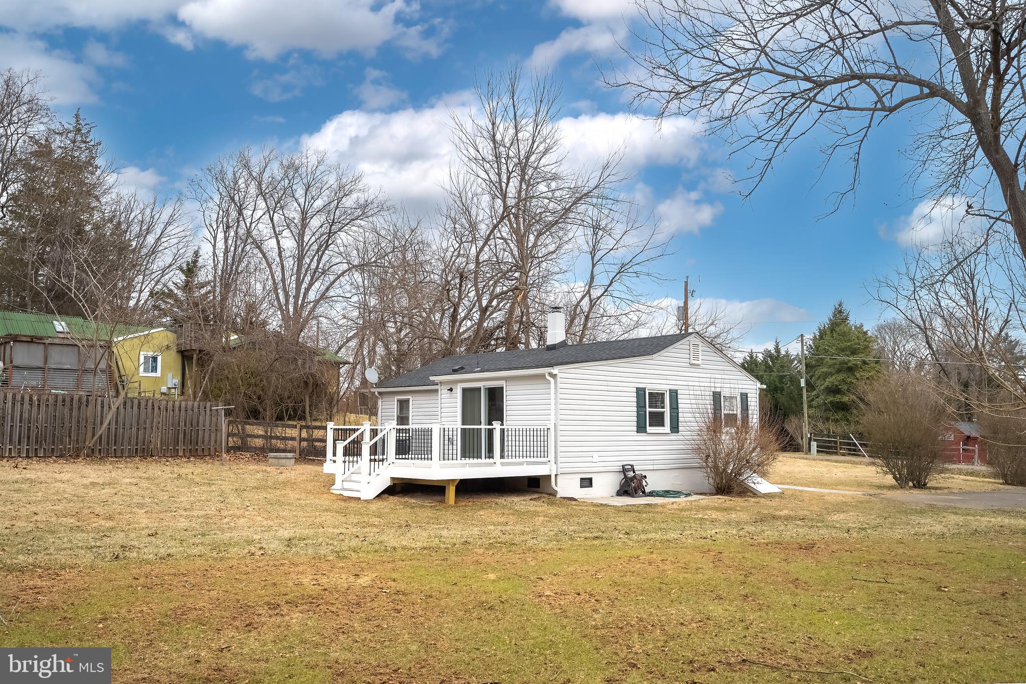 6946 Blantyre Road Warrenton, VA 20187 - Photo 21 of 24 a view of a house with a yard covered with snow in the background