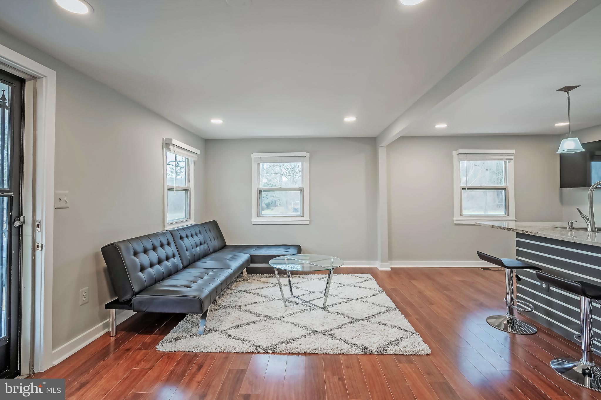 6946 Blantyre Road Warrenton, VA 20187 - Photo 4 of 24 a living room with furniture and a wooden floor