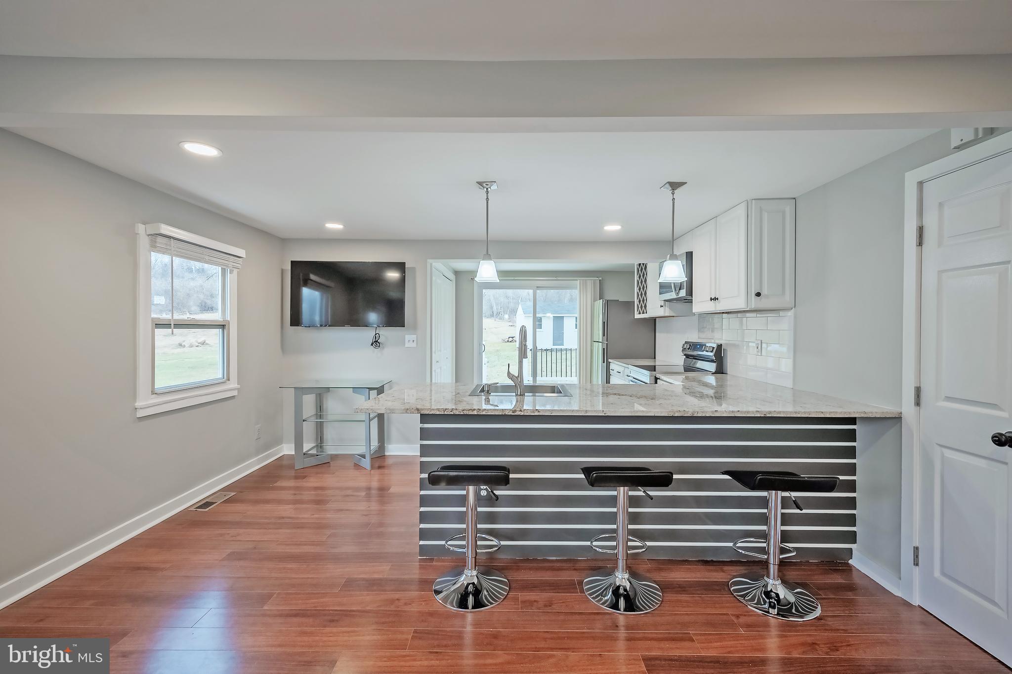 6946 Blantyre Road Warrenton, VA 20187 - Photo 6 of 24 a view of kitchen with wooden floor and window