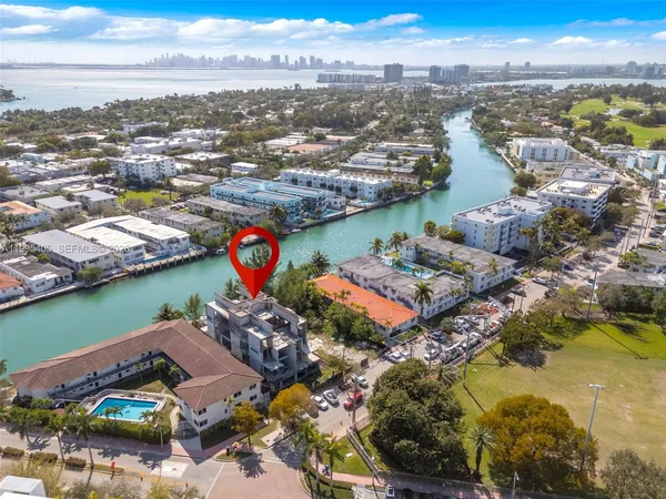 an aerial view of lake and residential houses with outdoor space