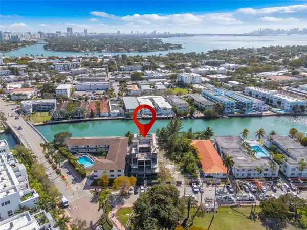 an aerial view of a house with a garden and lake view