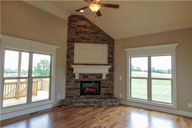 704 Academy Road, Unit 3C Lebanon, TN 37087 - Photo 5 of 20 a view of an empty room with wooden floor fireplace and a window