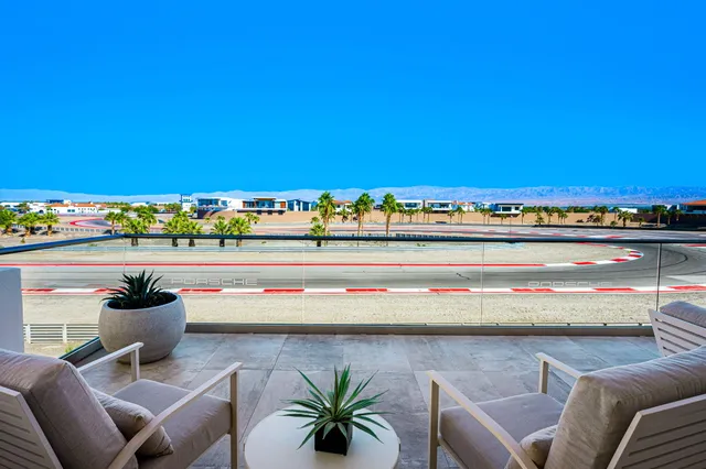 a kitchen with stainless steel appliances a table chairs in it and wooden floor