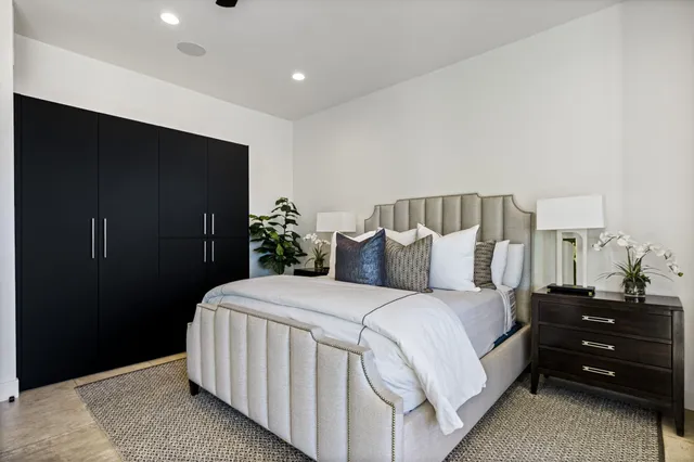 a bedroom with a bed and glass windows