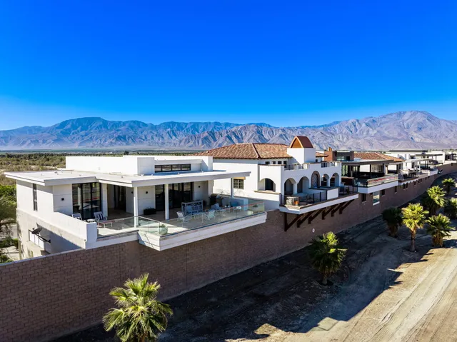 a view of a living room with a table and chairs