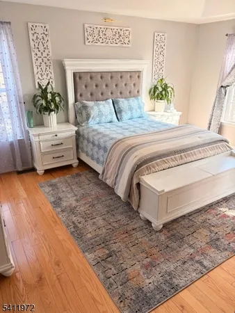 a bedroom with a bed a couch and a window